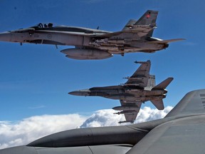 Royal Canadian Air Force CF-188 Hornets are refueled by a KC-135 Stratotanker assigned to the 340th Expeditionary Air Refueling Squadron on October 30, 2014, over Iraq during the first combat mission in the area of operations, supporting Operation Inherent Resolve.

(U.S. Air Force Photo by Staff Sgt. Perry Aston)
141030-F-MG591-637