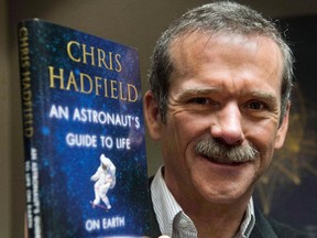 Retired Canadian astronaut Chris Hadfield holds a copy of his previous book "An Astronaut's Guide to Life on Earth."  He's at the NAC on Nov. 21.