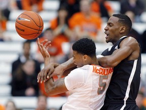 Syracuse's Chris McCullough, left, battles for a rebound against Carleton's J.E. Pierre-Charles, right, in the first half of an NCAA college basketball game in Syracuse, N.Y., Sunday, Nov. 2, 2014.