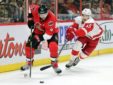 Chris Phillips clears the puck away from Riley Sheahan in the second period.