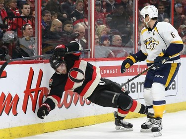 Clarke MacArthur of the Ottawa Senators is hit by Shea Weber of the Nashville Predators during first period NHL action.