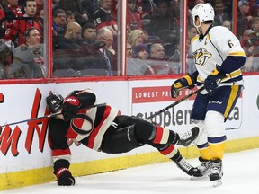 Clarke MacArthur of the Ottawa Senators is hit by Shea Weber of the Nashville Predators during first period NHL action.