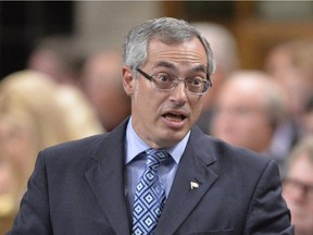 Treasury Board President Tony Clement answers a question during Question Period in the House of Commons on Parliament Hill in Ottawa, Thursday Sept.18, 2014 .