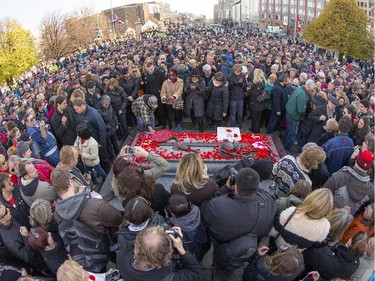 Crowds stand patiently waiting to place their poppy on the Tomb of the Unknown Soldier as the annual Remembrance Day Ceremony takes place at the National War Memorial in Ottawa.