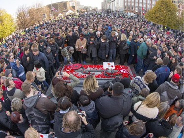 Crowds stand patiently waiting to place their poppy on the Tomb of the Unknown Soldier as the annual Remembrance Day Ceremony takes place at the National War Memorial in Ottawa.