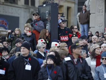 Crowds watch the Remembrance Day ceremony at the National War Memorial in Ottawa on Tuesday, November 11, 2014.