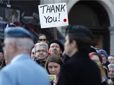 Crowds watch the Remembrance Day ceremony at the National War Memorial in Ottawa on Tuesday, November 11, 2014.