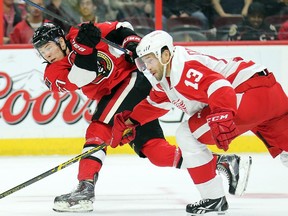 Curtis Lazar takes a shot with Pavel Datsyuk close behind in the first period.