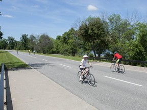 Cyclists ride where car traffic normally flows on Sir John A. Macdonald Parkway in Ottawa on Sunday, June 15, 2014.