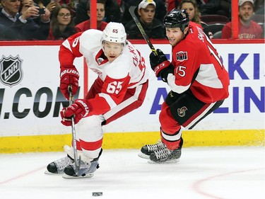 Danny DeKeyser clears the puck away from Zack Smith in the third period.