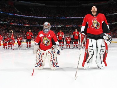 A young goalie stands with Craig Anderson #41 of the Ottawa Senators during the singing of the national anthems for Minor Hockey Week prior to a game against the Detroit Red Wings.