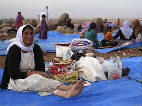 Displaced Iraqis from the Yazidi community settle at a camp at Derike, Syria, Sunday, Aug. 10, 2014.