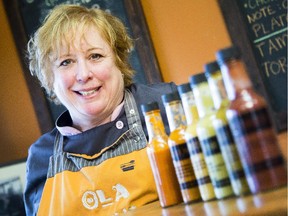 Donna Chevrier, owner of Ola Cocina, poses with some of her very hot, hot sauces in her Ottawa mexican restaurant Friday, November 7, 2014. (Darren Brown/Ottawa Citizen)