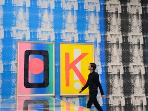 An employee poses next to an installation by Canadian artist Ciara Phillips entitled Things Shared 2014, during a press preview for the 2014 Turner Prize at the Tate Britain in London  (CARL COURT/AFP/Getty Images)