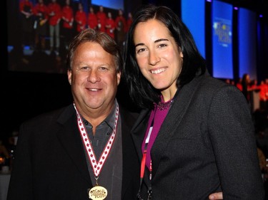 Dwight Brown, co-chair of Gold Medal Plates, with four-time Olympic gold medal hockey player Caroline Ouellette, at the fundraising dinner for Canadian Olympic athletes, held at the Shaw Centre on Monday, November 17, 2014.