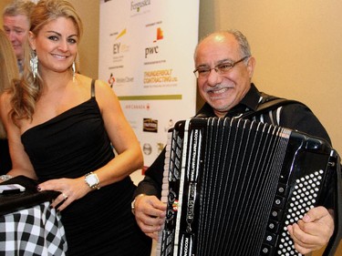 Elizabeth Figueroa gets serenaded by accordionist Laurino Pagliarello at the Italian-themed Mangia! Mangia! gala for the Queensway Carleton Hospital, held Saturday, Nov. 8, 2014, at the Sala San Marco.
