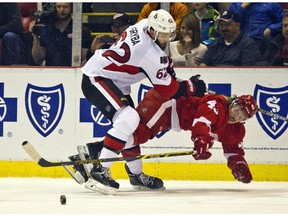 Ottawa Senators defenseman Eric Gryba (62) checks into Detroit Red Wings forward Darren Helm (43), during the first period.