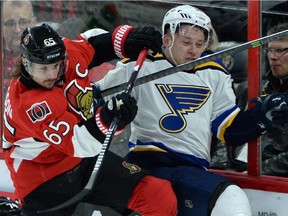 Ottawa Senators Erik Karlsson shoves St. Louis Blues Vladimir Tarasenko into the boards during NHL hockey action in Ottawa on Saturday, Nov. 22, 2014.