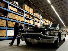 Conservator Erin Secord looks over a 1965 Ford Thunderbird which was donated by rock musician Randy Bachman at the Canadian Museum of Science and Technology in Ottawa on Thursday, March 3, 2011. The museum will remain closed for at least the rest of the year due to an infestation of mould.