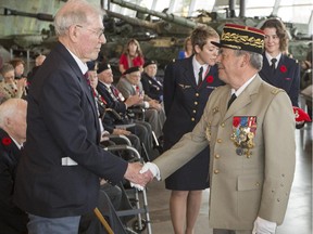Flying officer Russell McKay, left, is photographed receiving a Legion of Honour award from French army general, Hervé Gobilliard, president of the Société of the members of the Légion d'Honneur, at a ceremony at the Canadian War Museum Saturday.
