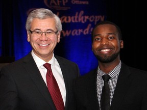 From left, United Way Ottawa CEO Michael Allen with Outstanding Youth recipient Patrick Twagirayezu at the AFP Ottawa Philanthropy Awards Dinner held at the Shaw Centre on Wednesday, Nov. 12, 2014.