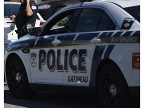 Gatineau police at the housing area where the gunman was believed to have barricaded himself in Gatineau, Thursday, Aug. 28, 2014. (James Park / Ottawa Citizen)