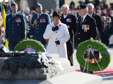 ilver Cross Mother Gisele Michaud takes a moment after placing a wreath during Remembrance Day ceremonies at the National War Memorial in Ottawa on Tuesday, November 11, 2014.