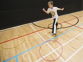 Guyllaume Desbiena takes part in an obstacle course put on by the Y Kids Academy health and fitness program in Orleans.