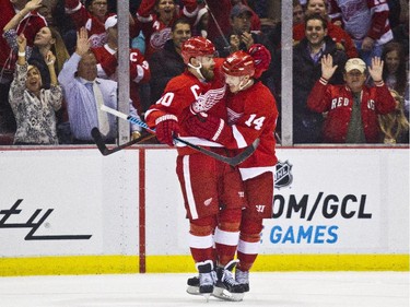 Detroit Red Wings forward Henrik Zetterberg (40), of Sweden, celebrates with forward Gustav Nyquist (14), of Sweden, after Nyquist scored a goal during the first period.