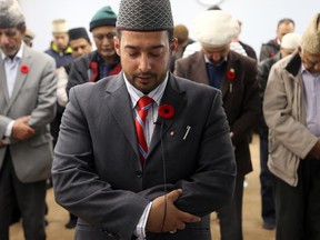 Imam Imtiaz Ahmed leads prayer on Friday at the mosque in Cumberland, where everyone wore poppies and he spoke of the importance of Remembrance Day to Canada and Muslims living here.