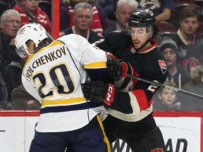 Jared Cowen of the Ottawa Senators battles against for,er Senators Anton Volchenkov of the Nashville Predators during first period NHL action.