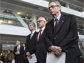 Federal Finance Minister Joe Oliver, right, and his Quebec counterpart, Carlos Leitao, and Jacques Bernier, left, of Teralys Capital arrive at a news conference to announce the creation of a capital-risk fund in Quebec Monday, November 10, 2014 in Montreal.