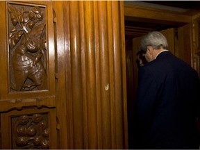 A bullet hole is seen in the wood frame as Secretary of State John Kerry enters the Library of Parliament on Parliament Hill in Ottawa, Canada, Tuesday, Oct. 28, 2014. Canadians are mourning the loss of Cpl. Nathan Cirillo, the army reservist who was shot dead as he stood guard before the Tomb of the Unknown soldier, whose shooting on Wednesday began an attack that ended with a lone gunman storming into Parliament and opening fire before being shot dead himself.