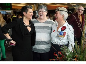 Julie Beun, left, who co-hosted Ladies Who Lunch at the Shaw Centre on Wednesday, chats with two retired veterans Debbie Kent, right, one of the guest speakers, and Shelley Colter.