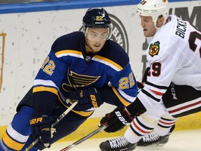 St. Louis Blues' Kevin Shattenkirk (22) skates around Chicago Blackhawks' Bryan Bickell (29) during the second period of an NHL hockey game, Saturday, Oct. 25, 2014, in St. Louis. The Blues won 3-2.(AP Photo/Bill Boyce)