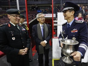 (L-R) Lieutenant General Marquis Hainse, Chief of the Army Staff and Commander of the Canadian Army, Korean Ambassador Cho Hee-yong and Defence Attaché Colonel Jang Min Choi share a laugh before presenting the trophy for the "Imjin Classic," a hockey game between Princess Patricia's Canadian Light Infantry (PPCLI) and Royal 22e Régiment (R22R) to commemorate the 100th anniversaries of two Regiments that served in the Korean War, at the Canadian Tire Centre on Nov. 29, 2014. The game is a re-enactment of the historic hockey matches played by the Regiments during the Korean War on frozen Imjin River.