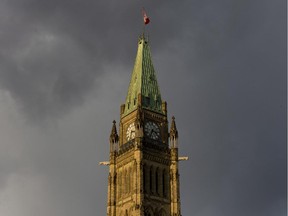 Files: Late afternoon sun catches the Peace Tower as storm clouds race past, Monday November 24, 2014