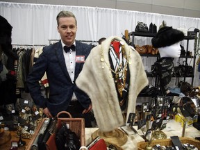 Marley McRae of the Rebel/Recluse store poses with vintage clothing and jewelry at the Ottawa Vintage Clothing Show at the Convention Centre on Saturday, Nov. 1, 2014.