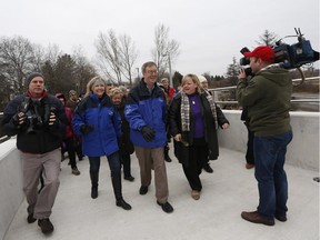 Mayor Jim Watson is joined by councillors, invited guests and hundreds of members of the public in crossing the newly opened Airport Parkway pedestrian bridge on Nov. 29, 2014.