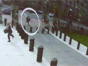 Michael Zehaf Bibeau is shown carrying a gun while running towards Parliament Hill on Oct. 22, 2014, in a still taken from video surveillance in this handout photo.