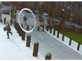 Michael Zehaf Bibeau is shown carrying a gun while running towards Parliament Hill in Ottawa on Wednesday, Oct. 22, 2014, in a still taken from video surveillance.