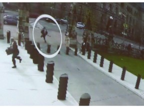 Michael Zehaf Bibeau is shown carrying a gun while running towards Parliament Hill in Ottawa on Wednesday, Oct. 22, 2014, in a still taken from video surveillance.