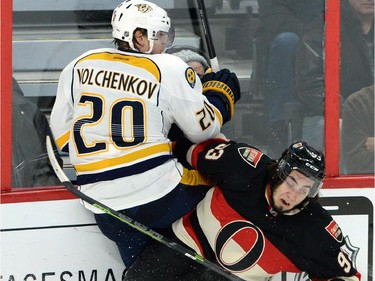 Ottawa Senators' Mika Zibanejad slams Nashville Predators' Anton Volchenkov into the boards during first period NHL hockey action.