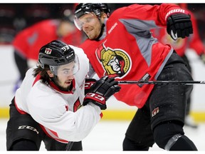 Mika Zibanejad (L) and Milan Michalek collide at practice. Both players are changing lines.
