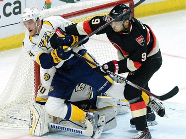 Ottawa Senators' Milan Michalek gives Nashville Predators' Mattias Ekholm a shove in front of his net during first period NHL hockey action.