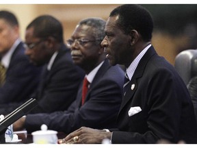 BEIJING, CHINA - JULY 19:  President of Equatorial Guinea Teodoro Obiang Nguema Mbasogo (R) speaks to his Chinese counterpart Hu Jintao (not pictured) during the 5th Ministerial Conference of the Forum on China-Africa Cooperation (FOCAC) held at the Great Hall of the People July 19, 2012 in Beijing, China.