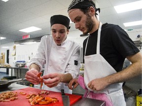 Mykelti St-Louis, left, and Stephen Beker work on their dish during the second edition of the Iron Chef competition at the University of Ottawa on Saturday, Nov. 8, 2014.