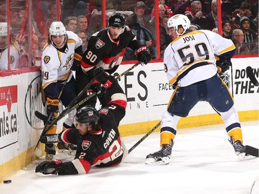 Jared Cowen #2 and Alex Chiasson #90 of the Ottawa Senators battle for a loose puck along the boards against Calle Jarnkrok #19 and Roman Josi #59 of the Nashville Predators.