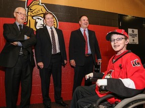 Jonathan Pitre meets with Ottawa Senators general manager Bryan Murray and assistant GM's Randy Lee and Pierre Dorion before signing a one day pro scouting contract prior to a game against the Nashville Predators at Canadian Tire Centre.