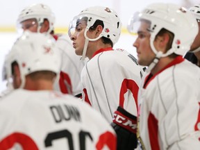 Nick Paul (middle) listens to the coaches during the Ottawa Senators' on ice portion rookie camp held at the Bell Sensplex in Ottawa, September 11, 2014.